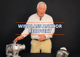 Man demonstrating windlass anchor recovery techniques with equipment on a table.