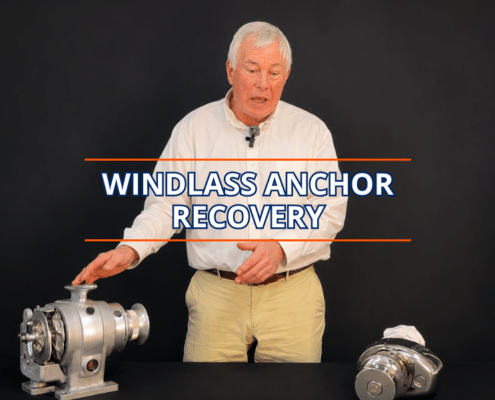 Man demonstrating windlass anchor recovery techniques with equipment on a table.