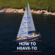 Sailboat demonstrating how to heave-to, with arrows on sails and scenic coastline background.