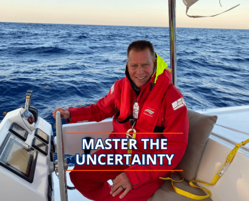 Sailor in red gear steering on open sea with text Master the Uncertainty.