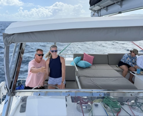 Bill Ibsen People enjoying a sailing trip on a yacht, navigating with a calm sea and clear skies for a perfect ocean adventure.