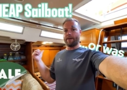 Man inside sailboat cabin with CHEAP Sailboat! and SALE text overlay. Bargain sailboat exploration.